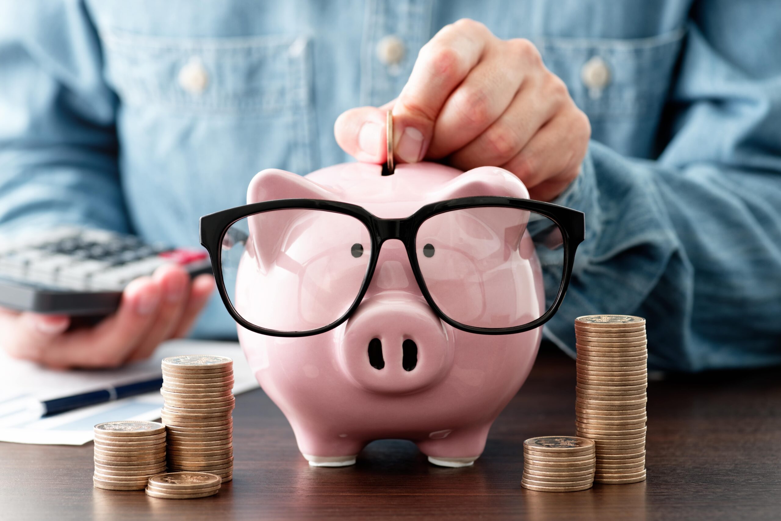man putting money in piggy bank