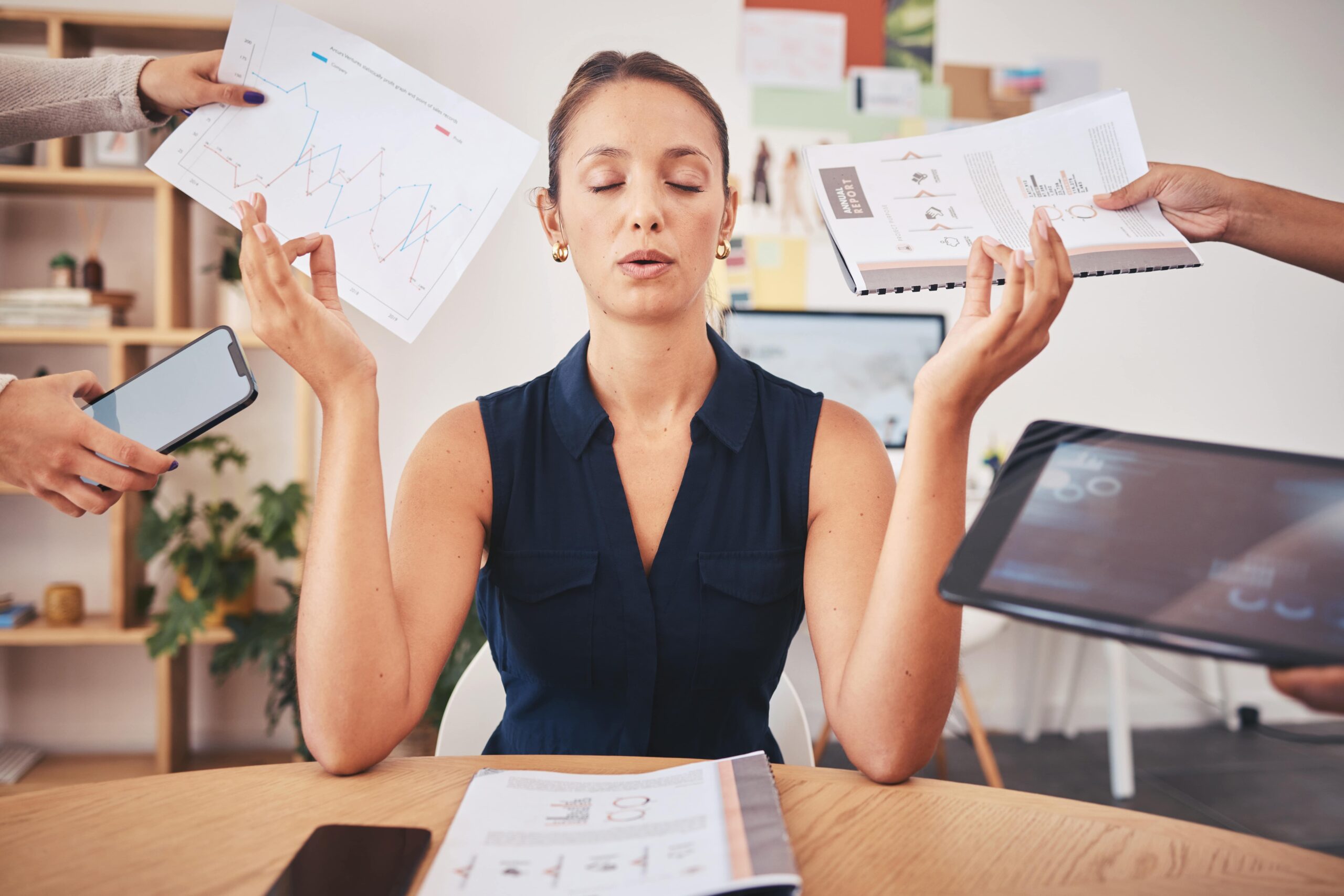 Young woman at the office meditating.