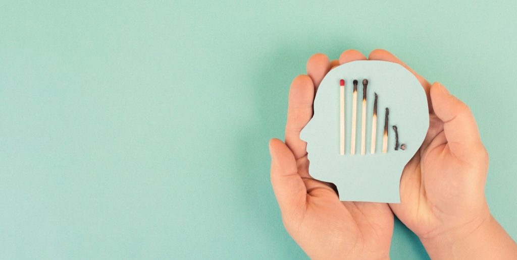 hands holding paper with burnt matches