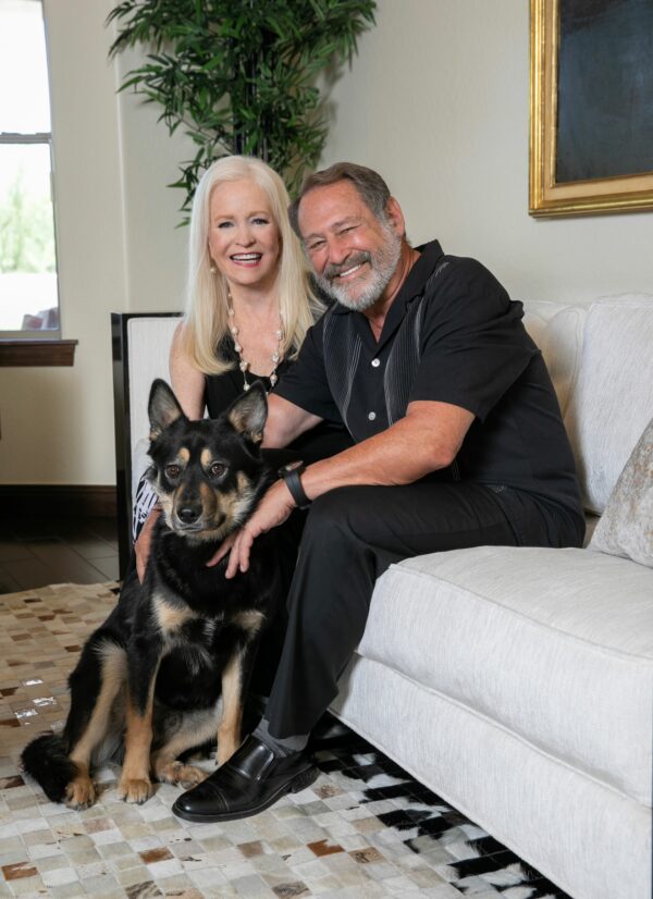 Sharon and Michael Lechter sitting together with their dog