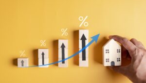 wooden blocks increasing in percentages leading to a house