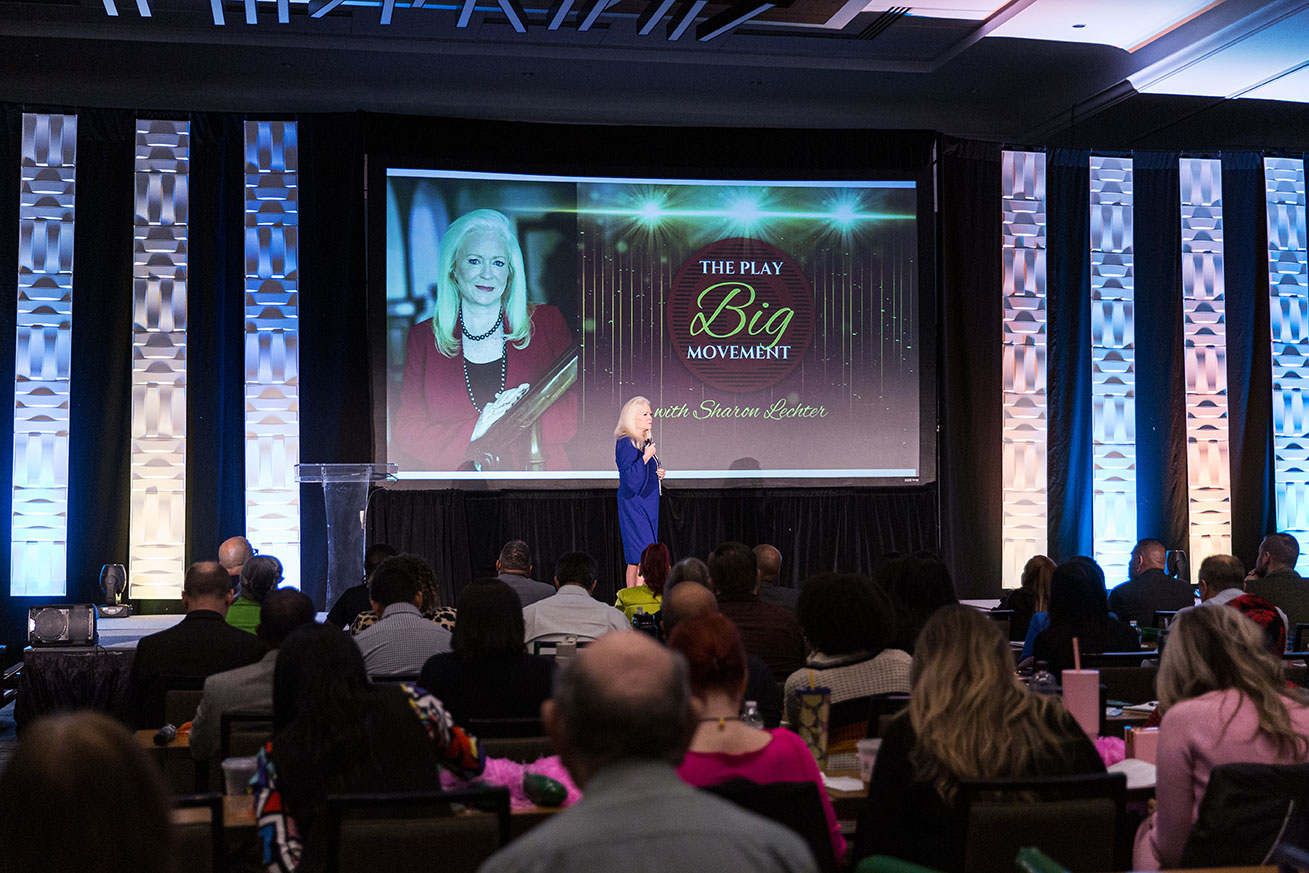 Sharon Lechter speaking to an audience about the big play movement