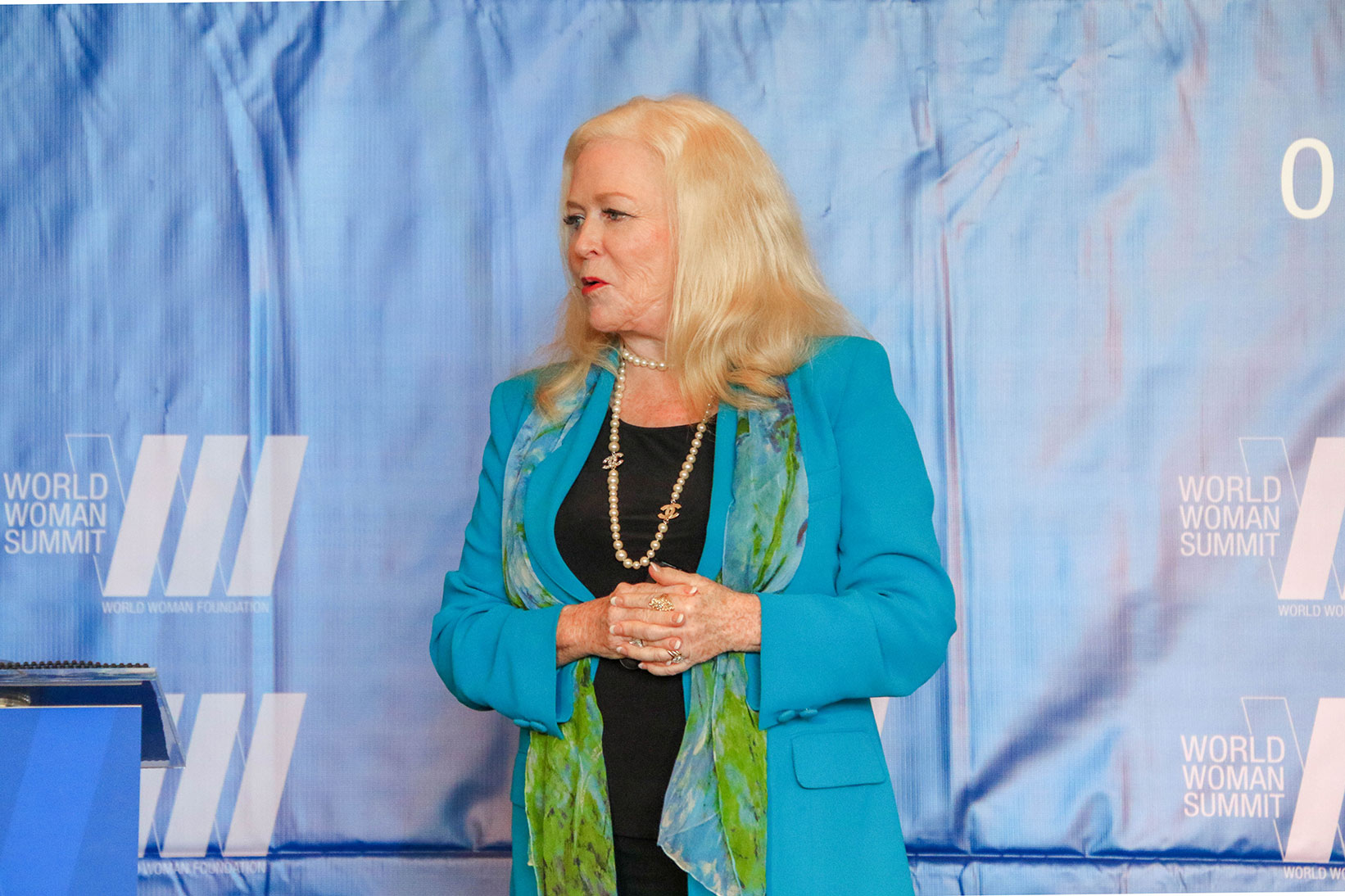 Sharon Lechter speaking on stage at the world women summit