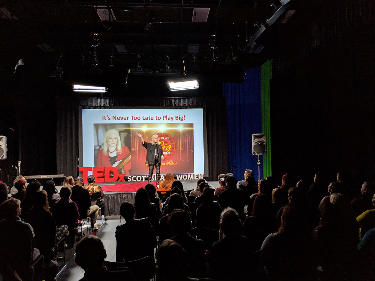 Sharon Lechter speaking at a TED talk conference with a presentation of its never too late to start highlighting the Big Play Movement