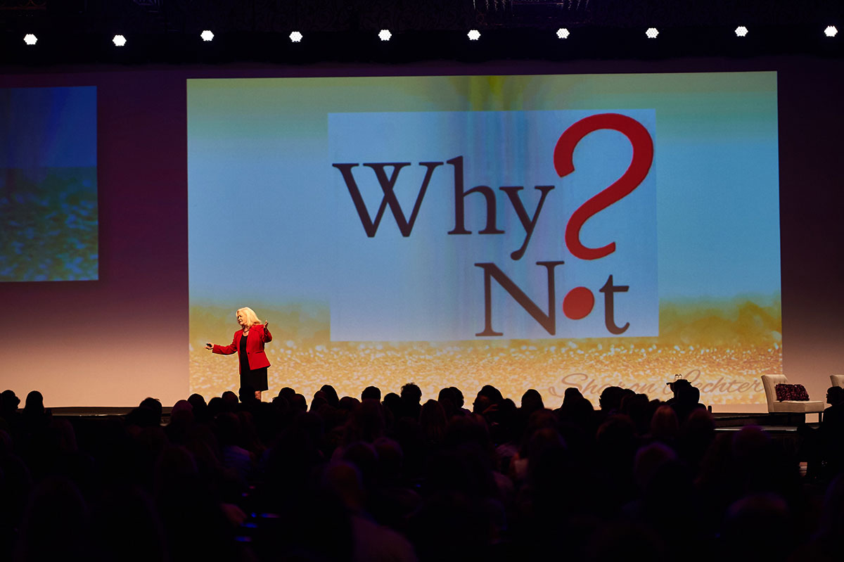 Sharon Lechter on stage with a presentation behind her “why not”