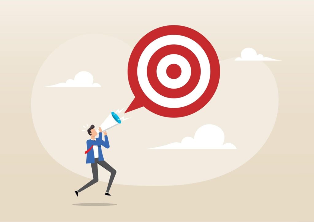 man shouting into a megaphone towards a large red target symbol in the sky