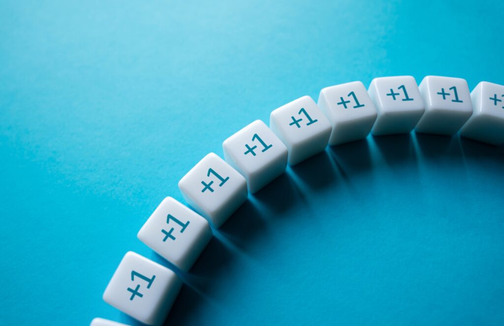 White cubes display "+1" in a curved line on a cyan background